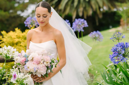 A beautiful bride wearing elegant 2026 bridal makeup with glowing skin, soft eye makeup, nude lips, and a stylish wedding hairstyle.